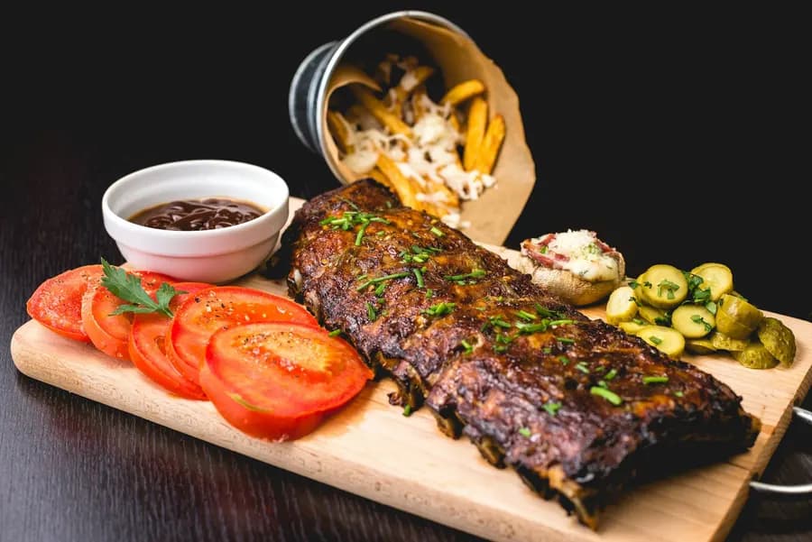 Flame-grilled meat on the braai stand